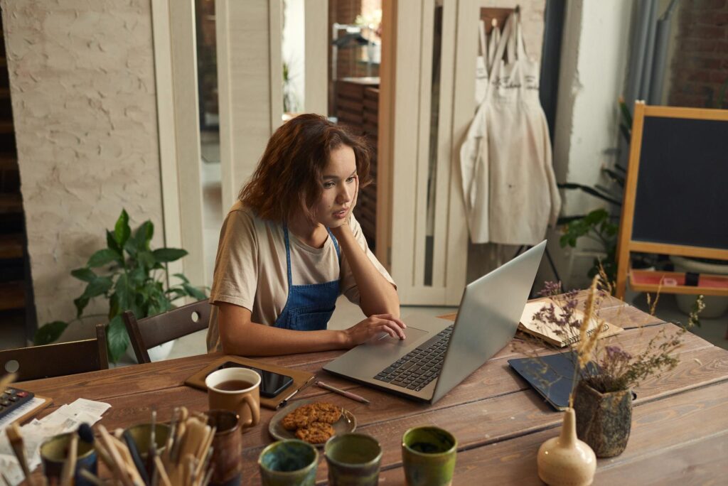 Woman working on laptop illustrating Microsoft 365 for business and remote productivity.