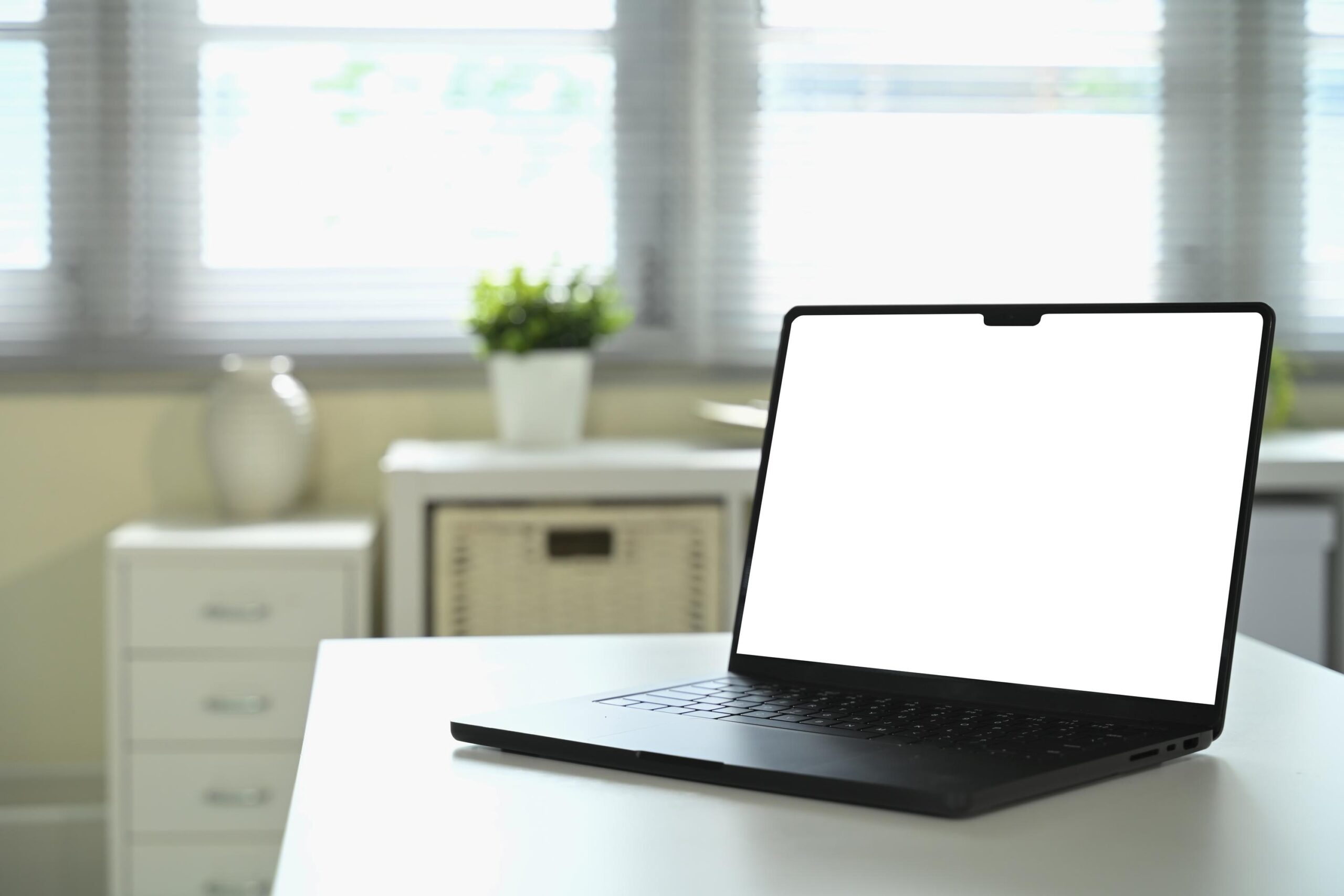 Laptop computer displaying a blank screen for website SEO audits and optimization.